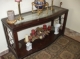 REDUCED this is a bargain for this item solid wood entrance table imported from and made in canada glass top and pewter on sides excellent quality.