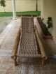 bamboo lounge chair with two white cushions hardly used
829-917-0610